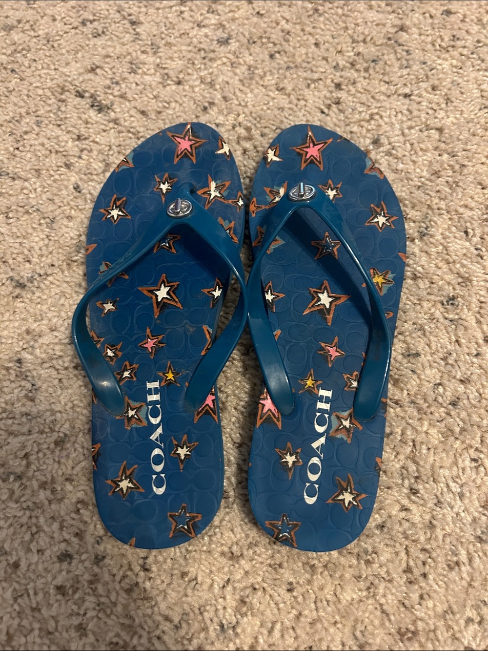 Coach Abbigail Flip Flops in a blue denim color with a colorful star pattern